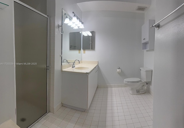 bathroom with vanity, toilet, a shower with shower door, and tile patterned flooring