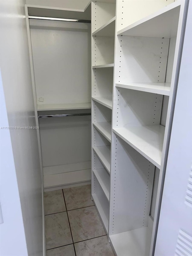 walk in closet with light tile patterned flooring