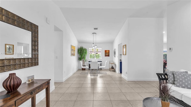 hall featuring light tile patterned floors