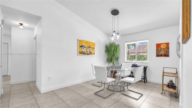 dining space with lofted ceiling and light tile patterned floors