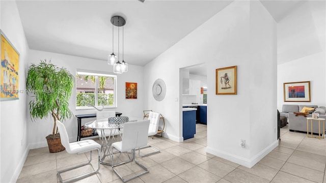 dining room with vaulted ceiling and light tile patterned floors