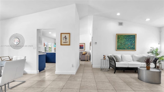 living room with lofted ceiling and light tile patterned floors