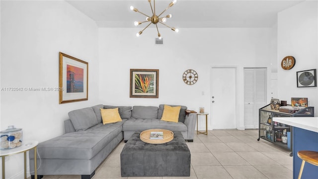 tiled living room with a notable chandelier and a towering ceiling