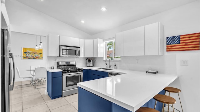 kitchen featuring stainless steel appliances, a breakfast bar, and white cabinets