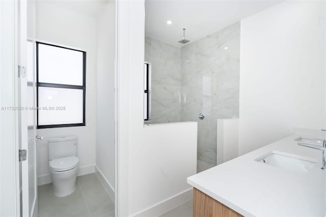 bathroom with vanity, tile patterned floors, toilet, and a shower