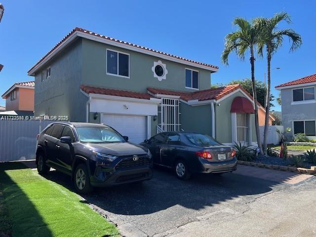 mediterranean / spanish-style home featuring a garage