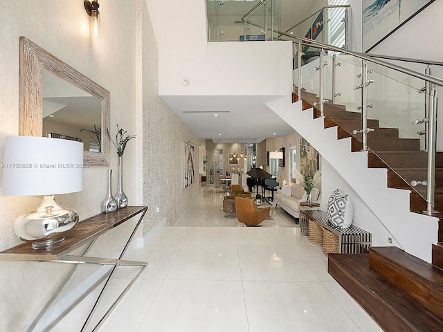 entryway with tile patterned floors and a high ceiling