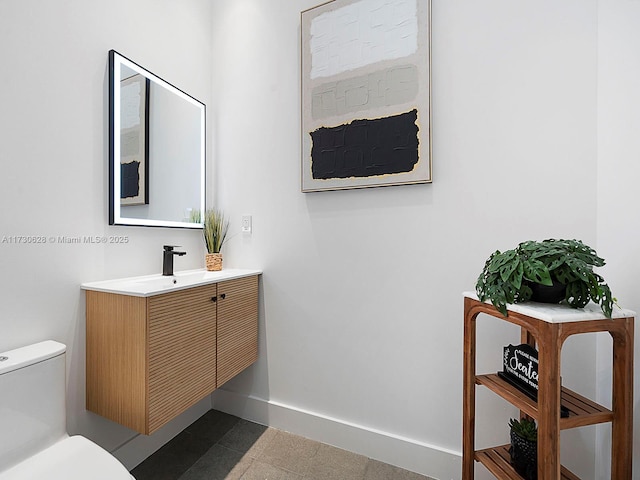 bathroom featuring vanity and toilet