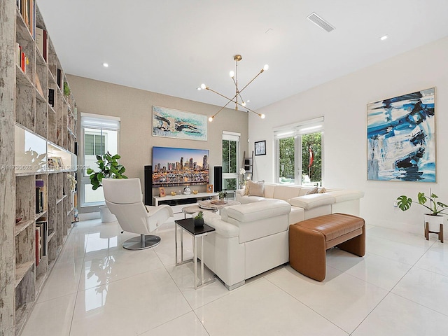 tiled living room featuring a notable chandelier