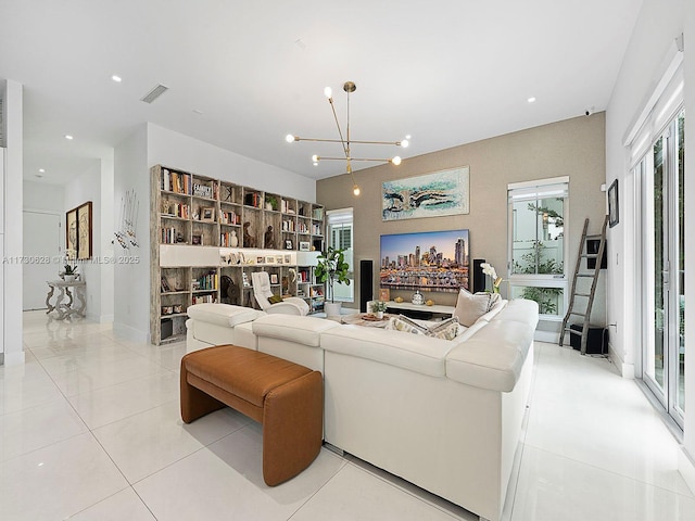 tiled living room featuring an inviting chandelier