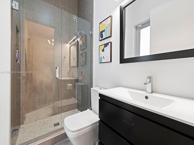 bathroom with vanity, an enclosed shower, and toilet