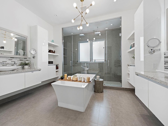 bathroom with tile patterned flooring, vanity, and separate shower and tub