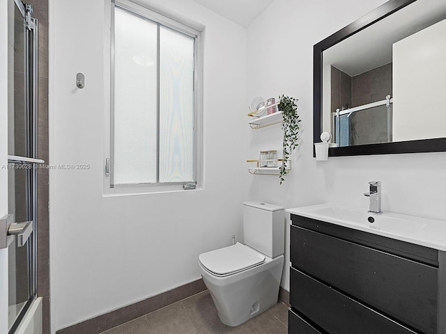 bathroom with vanity, an enclosed shower, tile patterned flooring, and a wealth of natural light