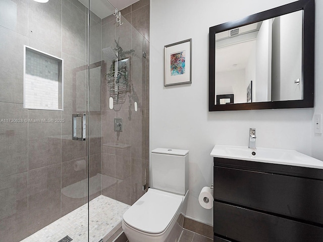 bathroom featuring vanity, an enclosed shower, and toilet