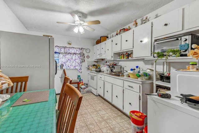 kitchen featuring sink, white cabinetry, a textured ceiling, ceiling fan, and white range with electric stovetop