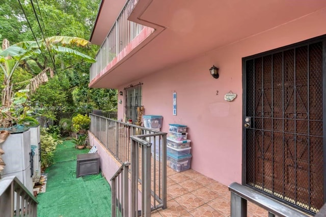 view of exterior entry with a balcony