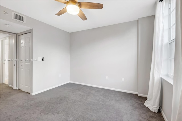 carpeted empty room with ceiling fan