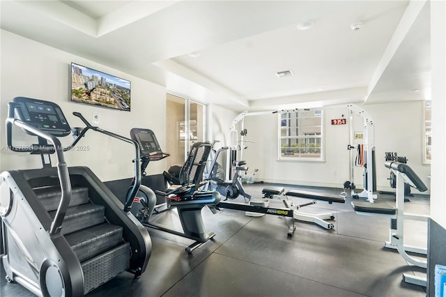 exercise room with a tray ceiling