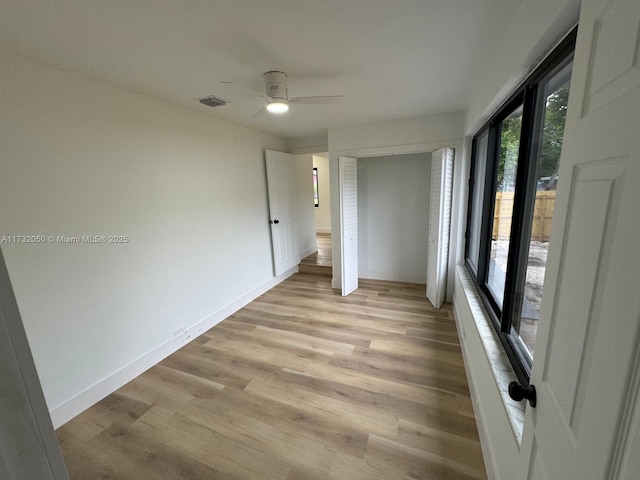 unfurnished room with ceiling fan and light wood-type flooring