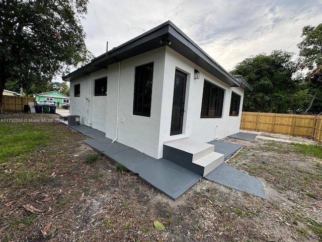 view of side of property featuring central AC unit