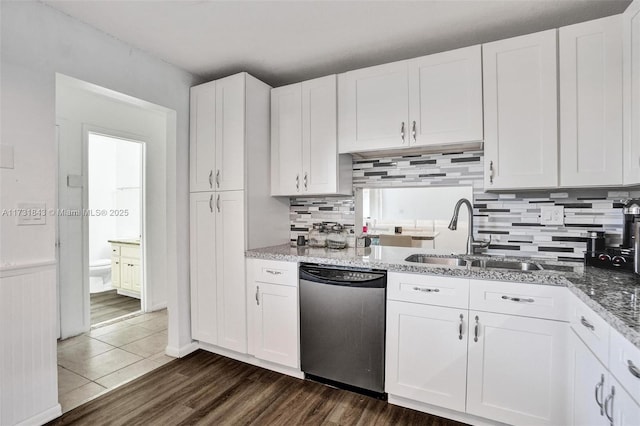 kitchen with white cabinetry, dark wood-type flooring, dishwasher, and sink