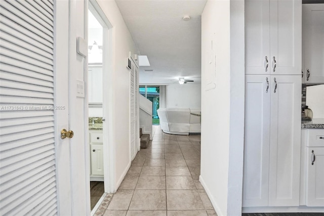 hallway featuring light tile patterned flooring