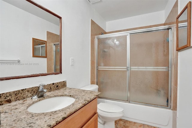 full bathroom with toilet, vanity, and shower / bath combination with glass door