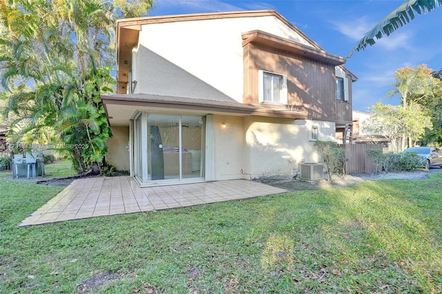 back of property featuring a yard, a patio area, and central air condition unit