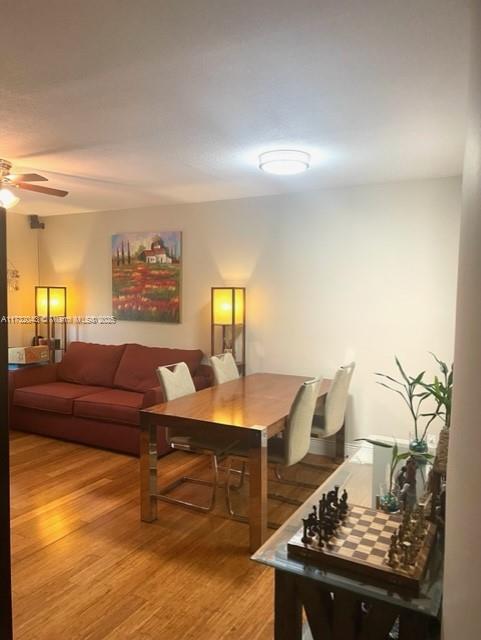 living room with hardwood / wood-style flooring and ceiling fan