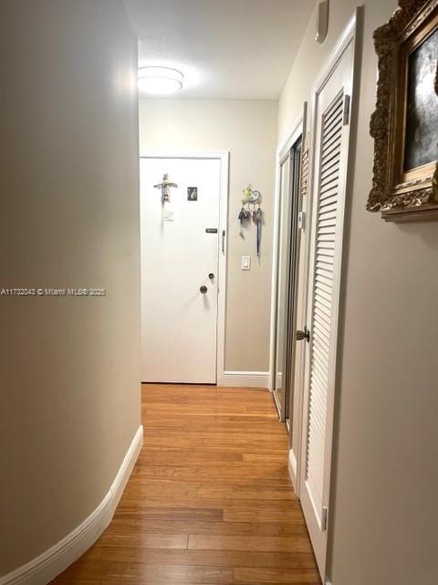 corridor with light hardwood / wood-style flooring