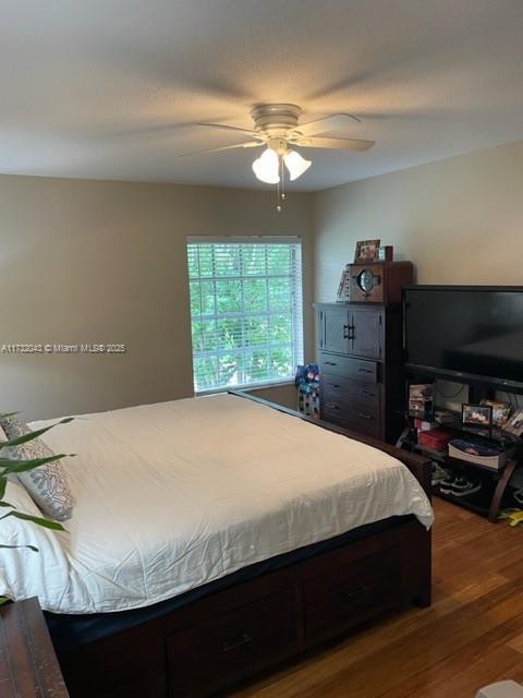 bedroom with hardwood / wood-style floors and ceiling fan