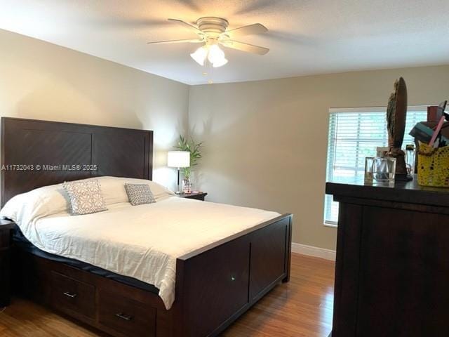 bedroom with ceiling fan and light hardwood / wood-style floors