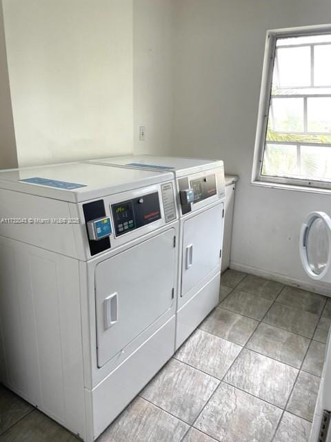 clothes washing area featuring washer and clothes dryer