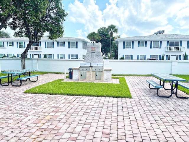 view of home's community with a patio and exterior kitchen