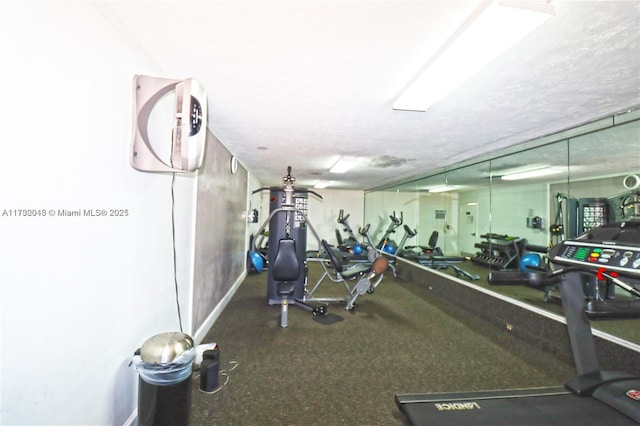 gym featuring a textured ceiling