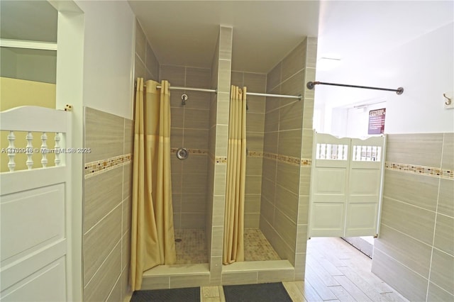 bathroom featuring tile walls and a shower with curtain