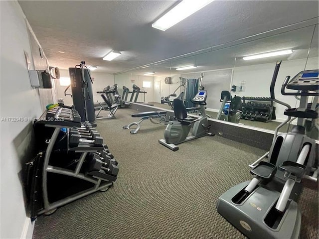 gym with carpet flooring and a textured ceiling