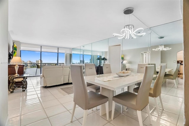 tiled dining space with floor to ceiling windows and a notable chandelier