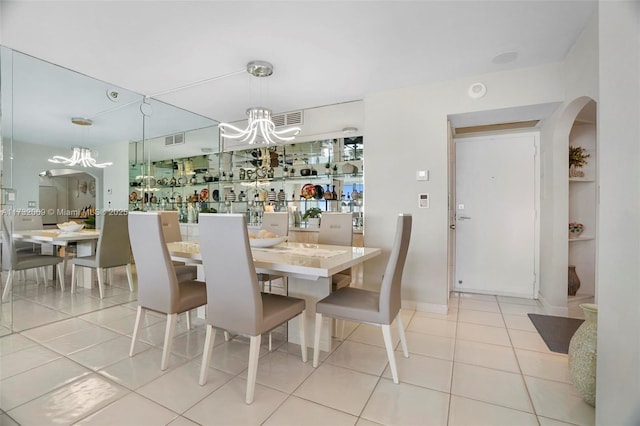 dining space featuring an inviting chandelier and light tile patterned floors