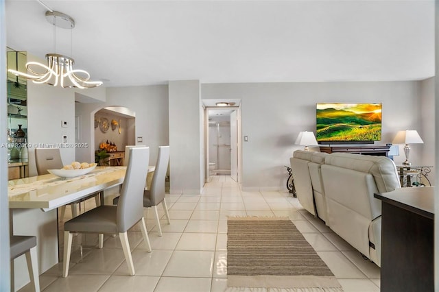 tiled dining space featuring a notable chandelier