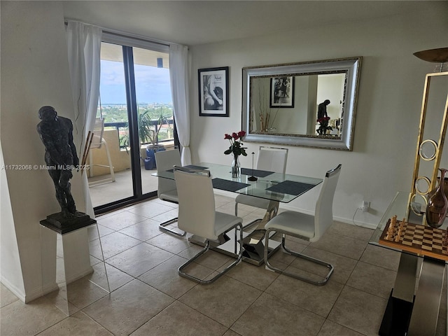 tiled dining space featuring floor to ceiling windows