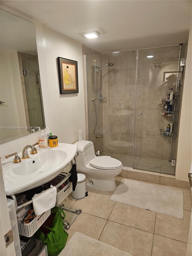 bathroom featuring tile patterned flooring, an enclosed shower, vanity, and toilet