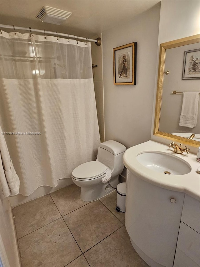 full bathroom with vanity, shower / tub combo, tile patterned floors, and toilet