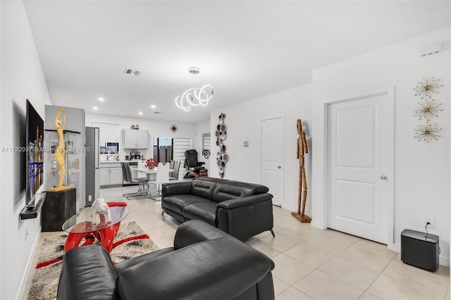 tiled living room featuring a chandelier