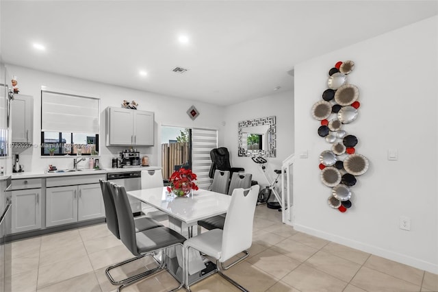 dining area featuring sink and light tile patterned floors