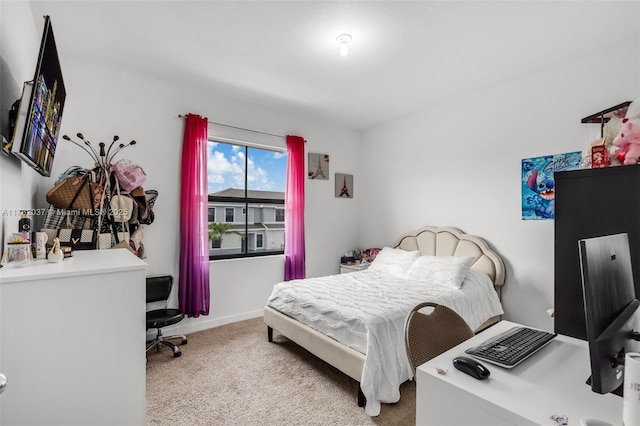 bedroom featuring light carpet