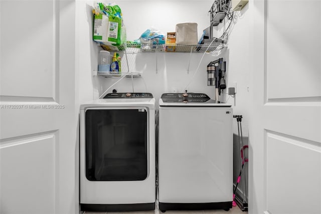 washroom with washing machine and clothes dryer