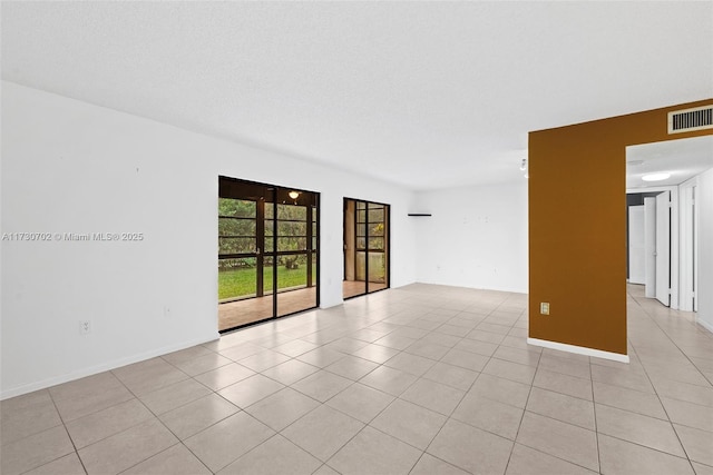 spare room with light tile patterned floors