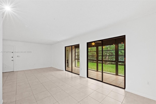 unfurnished room featuring light tile patterned floors