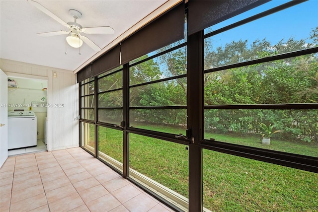 unfurnished sunroom featuring ceiling fan and washer / clothes dryer